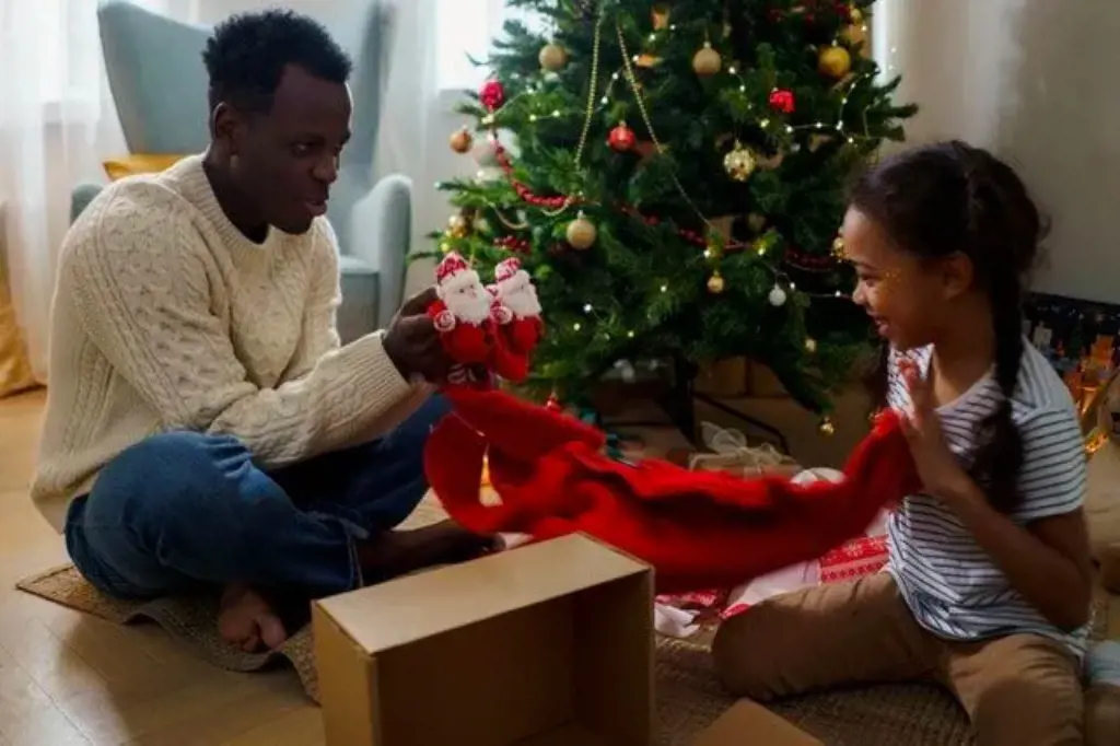 Who doesn't like opening Christmas gift. Father and daughter opening their gift