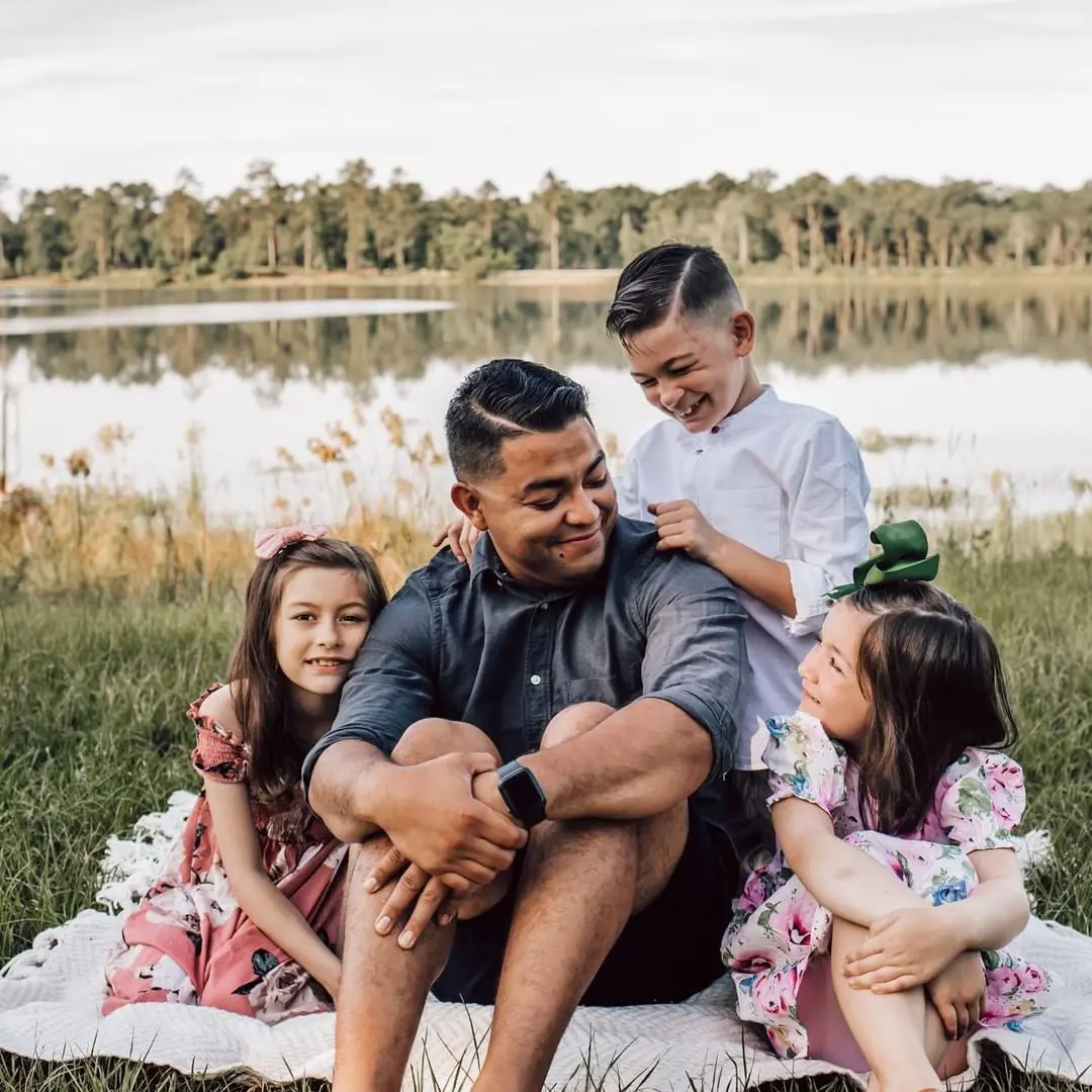 A portrait of kids enjoying their time with their dad as the moment is captured by photographer Christina Marie