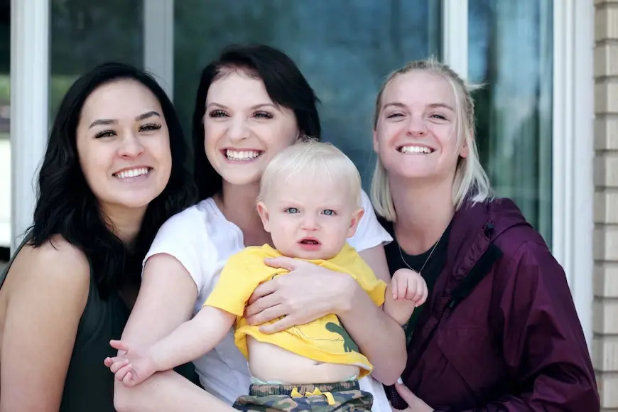 Relatives happy to be holding the child