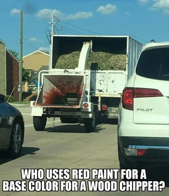 The woodchipper being towed by a truck looks suspicious with the red paint.