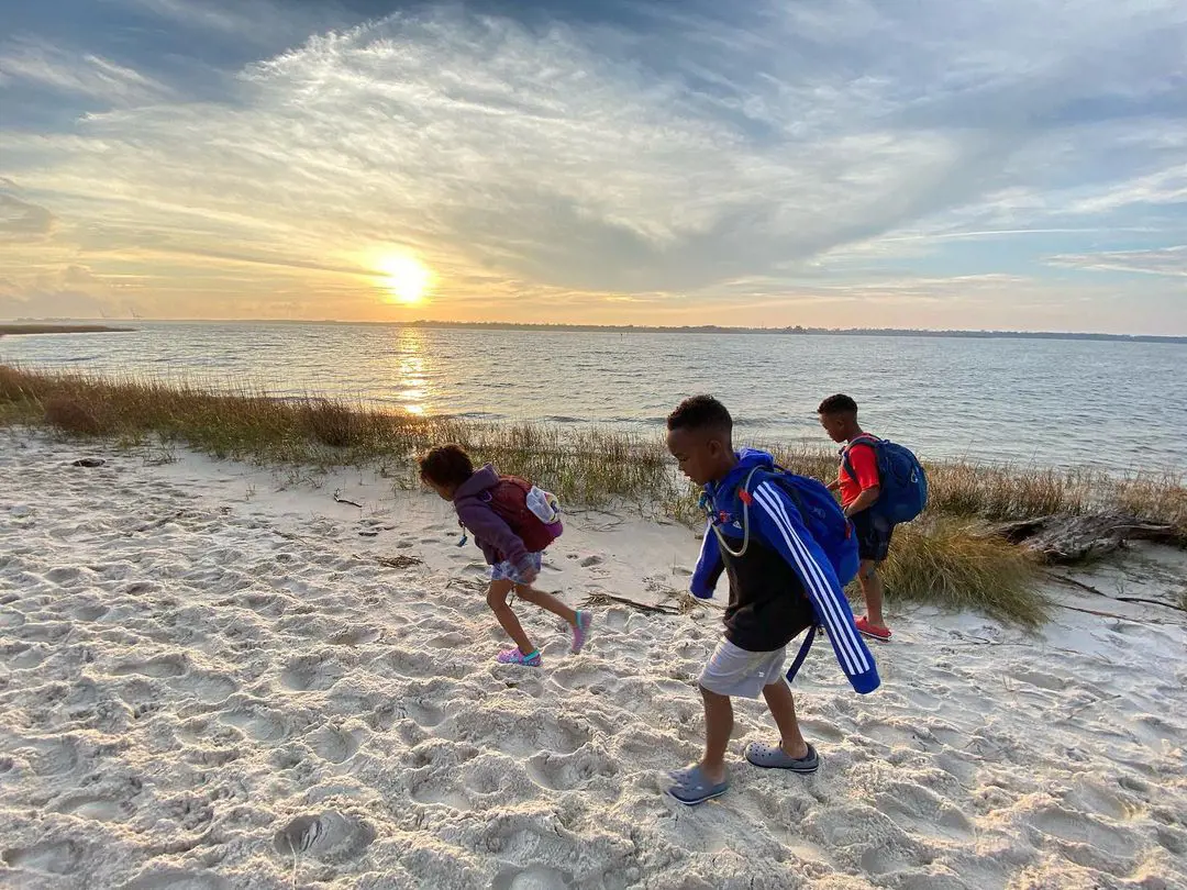 Kids enjoy their evening walk on the beach